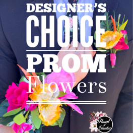 Person in a suit holding a bright floral boutonniere and wrist corsage.