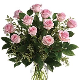 Pink roses arranged in a clear glass vase