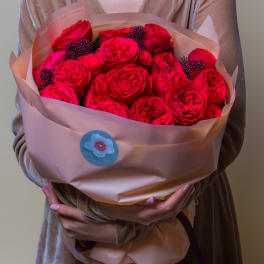 Bouquet of bright pink roses wrapped in blush paper