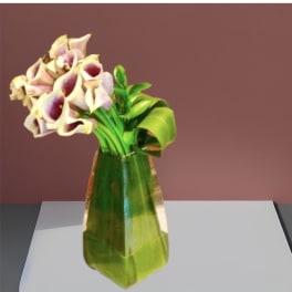 Bouquet of white and purple calla lilies in a green glass vase