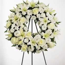 White floral wreath on a black easel