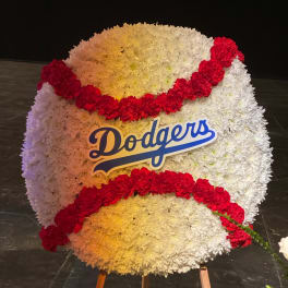 Large Dodgers floral display with white and red flowers on an easel