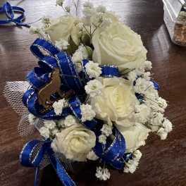 Small bouquet of white roses with blue ribbon and baby's breath