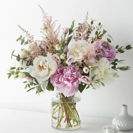 Pink and white bouquet in a clear glass vase