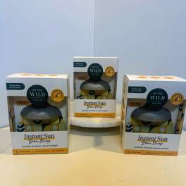 Three boxed grow lamps on a table.