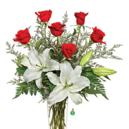 Tall glass vase arrangement with red roses and white lilies