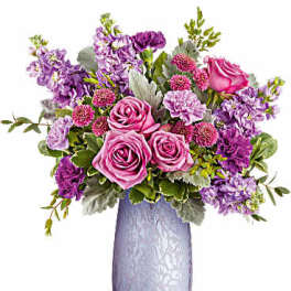 Pink and purple rose bouquet in a lavender vase