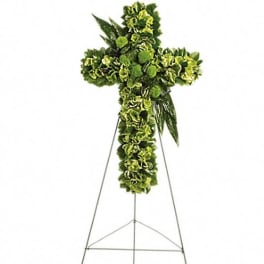 Green floral standing cross on a metal easel