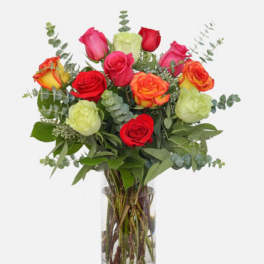 dozen mixed colors rose in a vase with eucalyptus