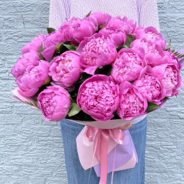 Large bouquet of bright pink peonies wrapped with pink ribbon