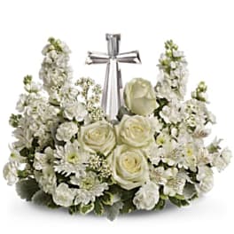 White floral sympathy arrangement with a silver cross centerpiece