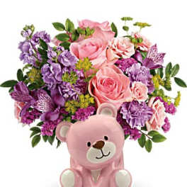 Pink teddy bear planter with pink and purple flowers