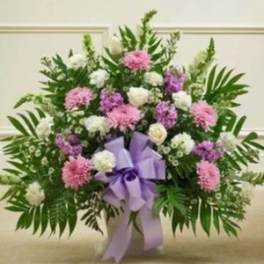 Pink and white floral spray with a lavender ribbon bow