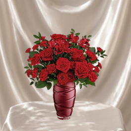 Red roses and carnations in a tall red vase