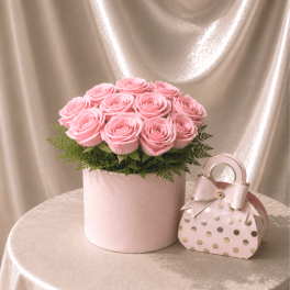 Pink roses in a round box with a matching gift box