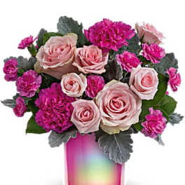Pink roses and magenta carnations in a pink glass vase