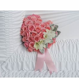 Pink rose bouquet with pale orchids and a pink ribbon