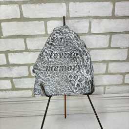 Memorial stone on a metal stand with the words "In loving memory"