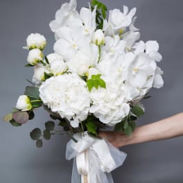 White floral bouquet with a satin and lace ribbon wrap