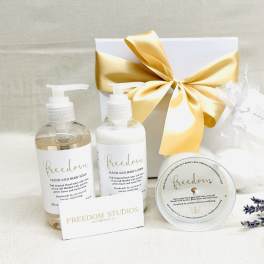 Gift set with soap, lotion, candle, and a ribbon-tied box