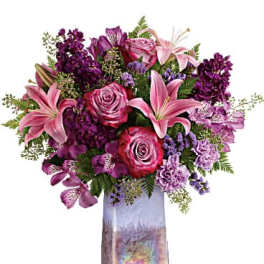 Pink and purple mixed bouquet in a tall iridescent vase