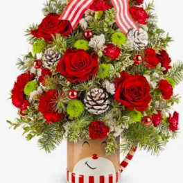 Christmas tree-shaped floral arrangement with red roses and striped ribbon