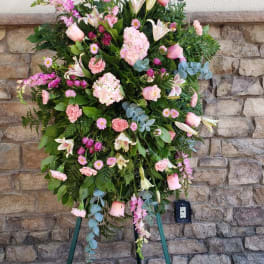 Tall pink and white floral standing spray on a tripod easel
