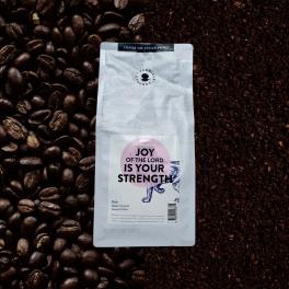Bag of ground coffee on coffee beans