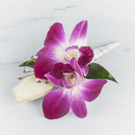 Pink orchid boutonniere with white rose bud and crystal accents