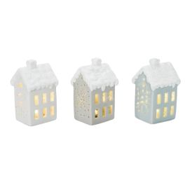 Three small ceramic house lanterns with glowing windows and snowy roofs