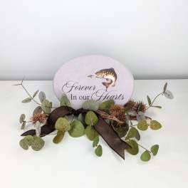 Memorial plaque with eucalyptus and a dark ribbon