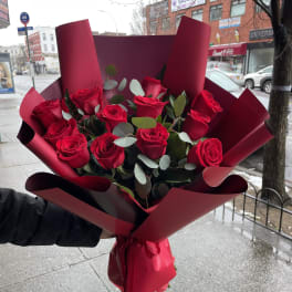 Bouquet of red roses wrapped in burgundy paper