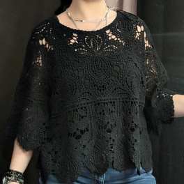 Person wearing a black lace top with blue jeans