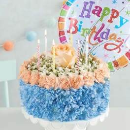 Birthday cake made of flowers with candles and a balloon