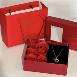 Red gift box with rose-shaped soap flowers and a heart necklace