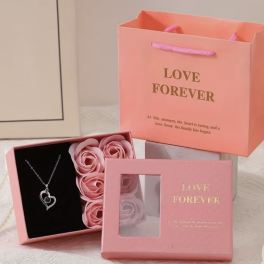 Pink gift boxes with faux roses and a heart necklace