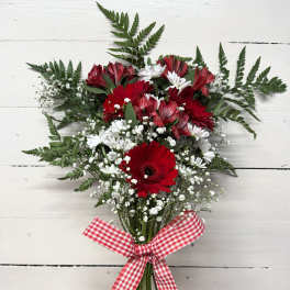 Red and white bouquet with daisies and baby's breath tied with a gingham ribbon