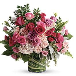 Pink and lavender rose bouquet in a glass vase