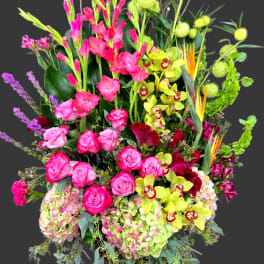 Tall mixed bouquet with pink roses, orchids, and green hydrangeas