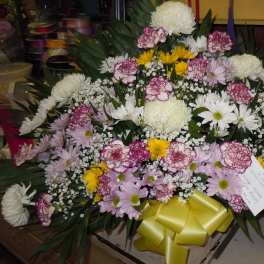 Large mixed flower spray with a yellow ribbon bow