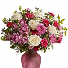 Pink and white roses arranged in a pink vase