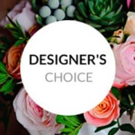Designer’s choice floral arrangement with pink and peach roses