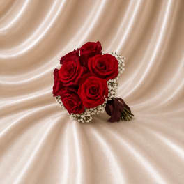 Bouquet of red roses with white filler flowers and a burgundy ribbon