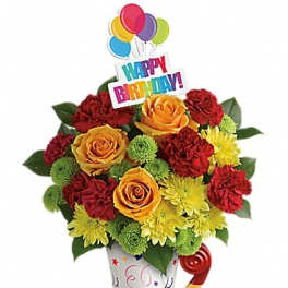 Birthday bouquet with roses, carnations, and a colorful balloon topper in a party cup