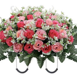 Pink rose casket spray with white filler flowers and greenery