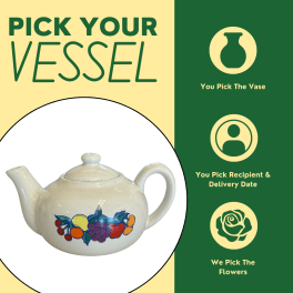 Cream teapot-shaped vase with a fruit design