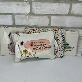 Floral zip pouches with tassels and printed wildflower designs