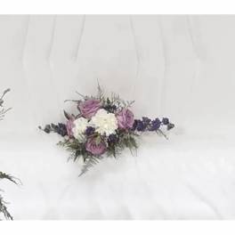 White dress with a small purple and white floral corsage