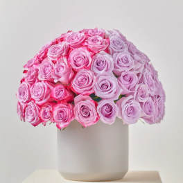 Round bouquet of pink roses in a white vase