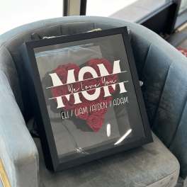 Framed arrangement of red roses with a "Mom" message